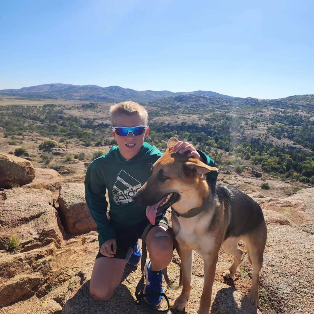 Lucas Scott and Maverick hike in the Wichita Mountains. The Scott family maintains bee yards next to Fort Sill and in Medicine Park. They enjoy hikes after working the bees. Photo courtesy of Sweet Stingers.