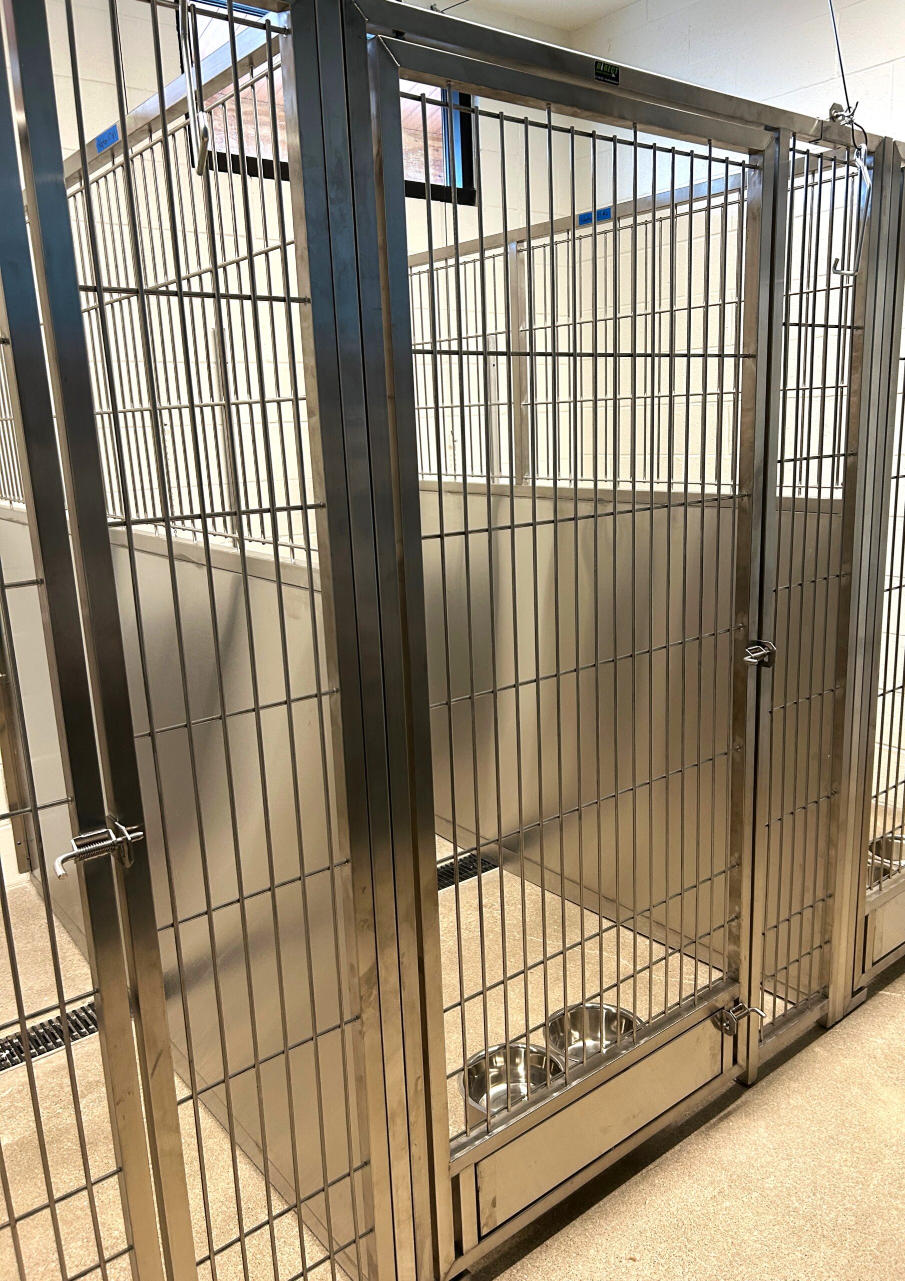 Stainless steel dog kennels at the new Sand Springs Animal Welfare shelter will allow staff members and volunteers to feed the dogs and open the doors to their outside runs without having to enter the kennels. Photo by Sharon Bishop-Baldwin.